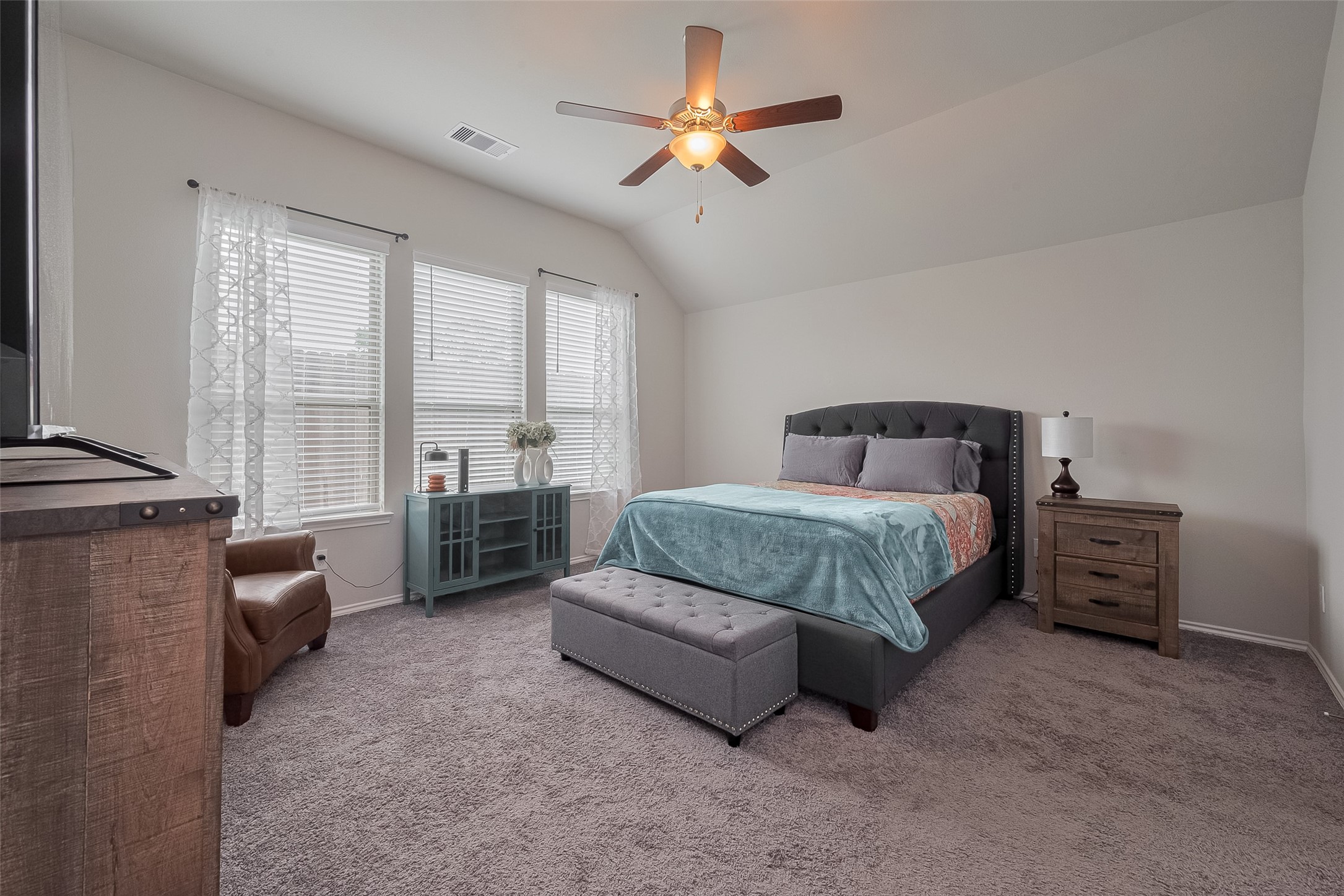 25446 Fossa Drive Tomball, TX 77375 - Photo 13 of 29 a bedroom with a bed a couch and a chandelier