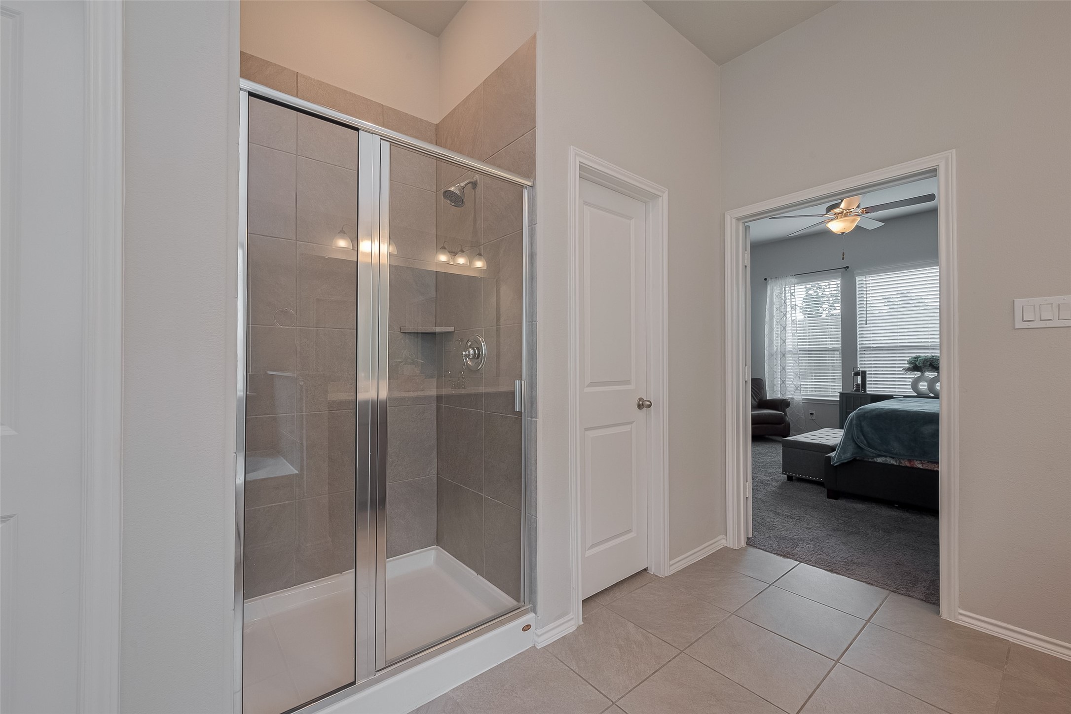 25446 Fossa Drive Tomball, TX 77375 - Photo 17 of 29 a bathroom with a glass door shower