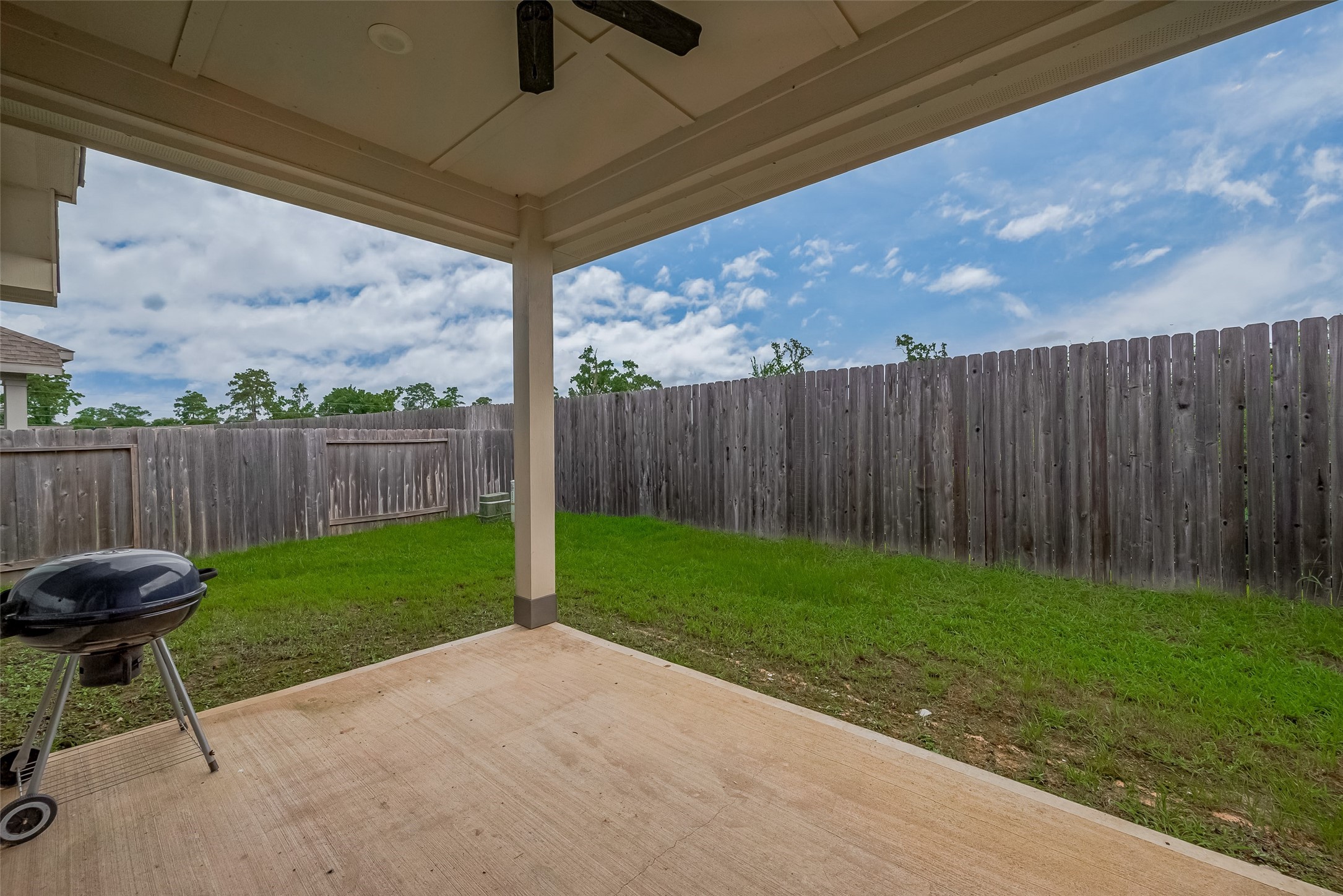25446 Fossa Drive Tomball, TX 77375 - Photo 27 of 29 a view of a backyard with wooden fence