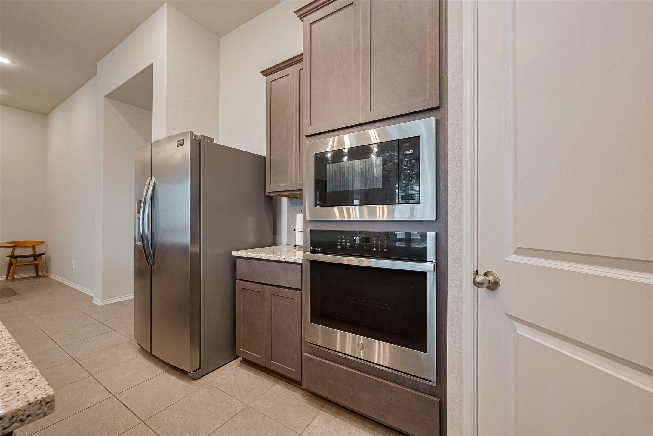 25446 Fossa Drive Tomball, TX 77375 - Photo 8 of 29 a kitchen with stainless steel appliances granite countertop a refrigerator and a stove