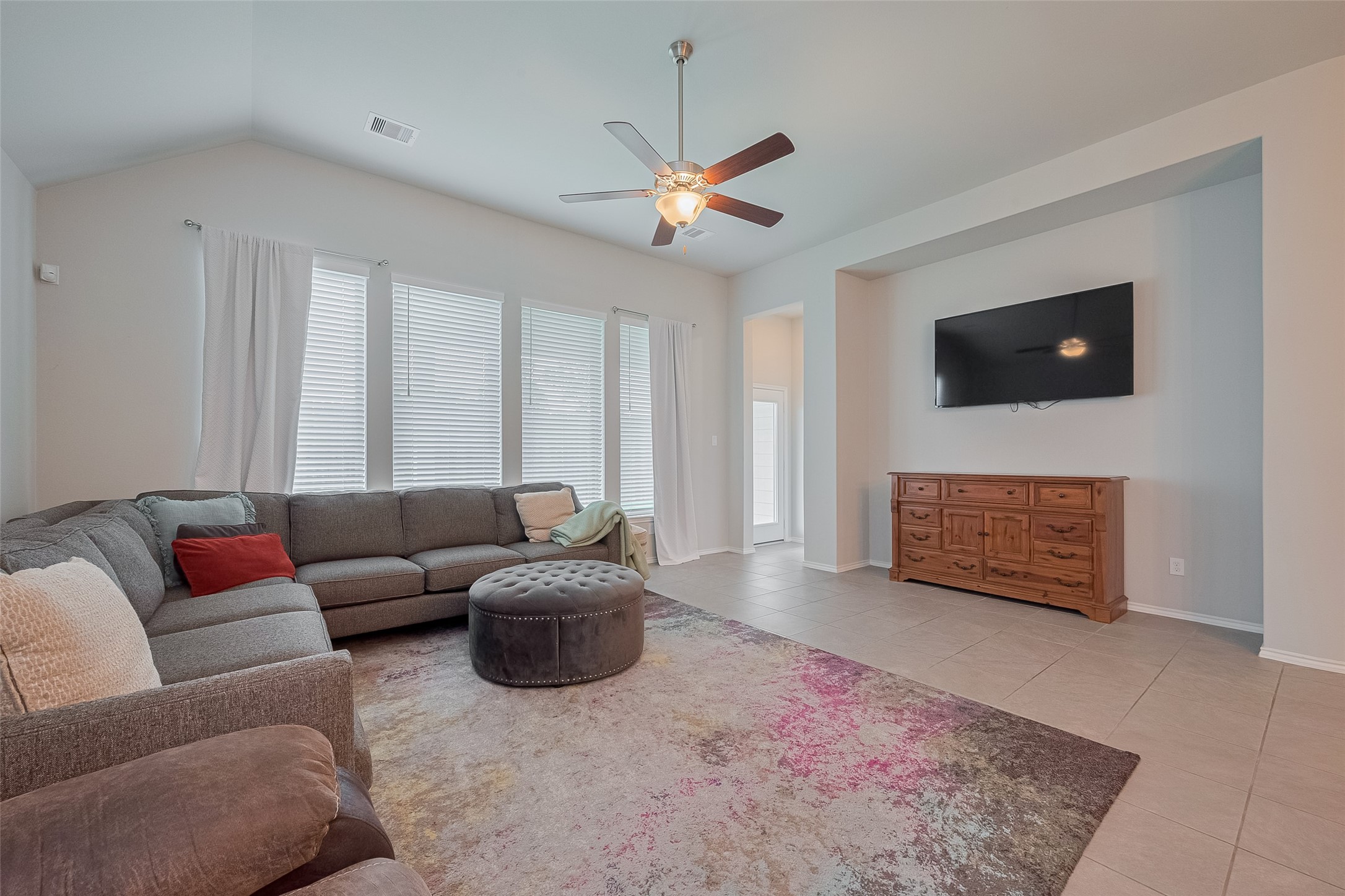 25446 Fossa Drive Tomball, TX 77375 - Photo 10 of 29 a living room with furniture a flat screen tv and a window