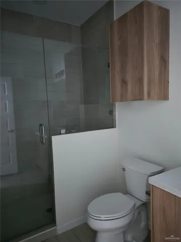 a bathroom with a toilet and a shower