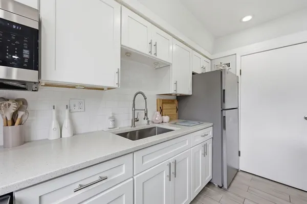 a kitchen with stainless steel appliances a sink and cabinets