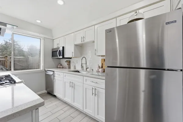 a kitchen with stainless steel appliances a refrigerator and a sink