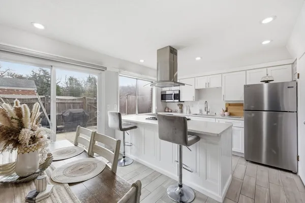 a kitchen with kitchen island a appliances and a dining table