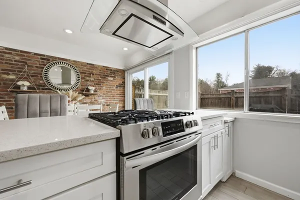 a stove top oven sitting inside of a kitchen