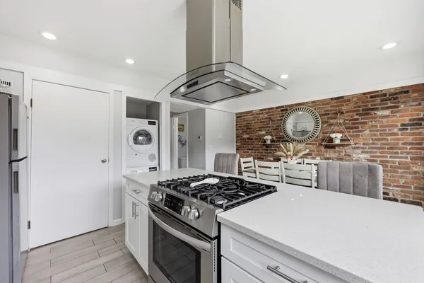 a kitchen with stainless steel appliances a stove a refrigerator and cabinets