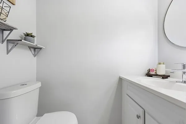 a bathroom with a sink a toilet and a mirror