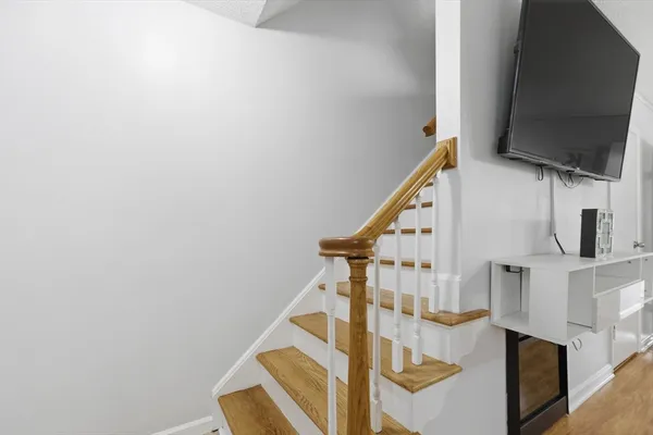 a view of entryway and hall with wooden floor