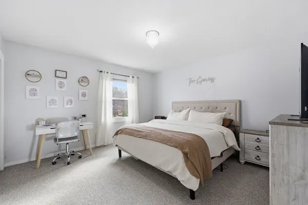 a bedroom with a bed chair and a window