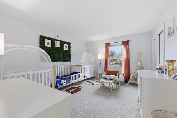 a bedroom with furniture and a large window