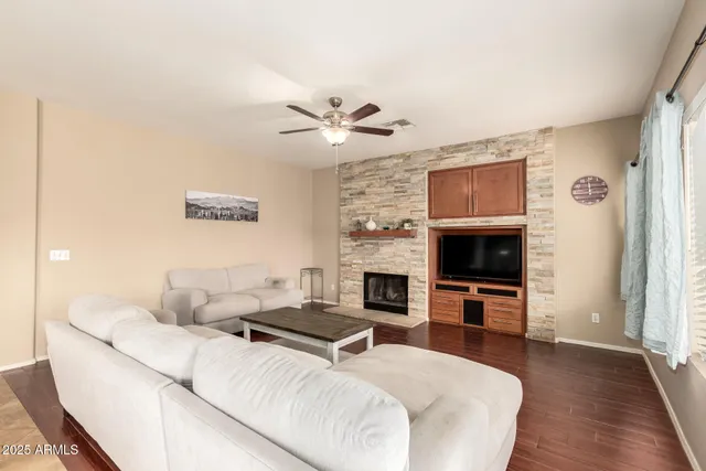 a living room with furniture a fireplace and a flat screen tv