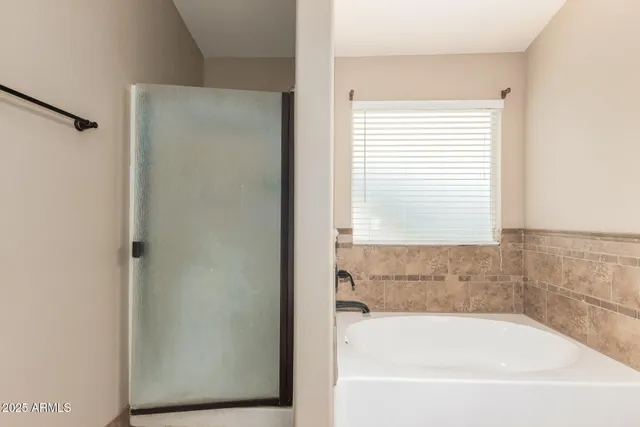 a bathroom with a bathtub and a window