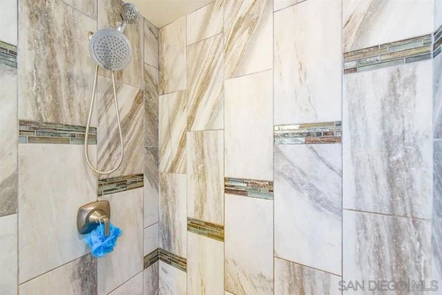 a bathroom with a shower curtain and a window