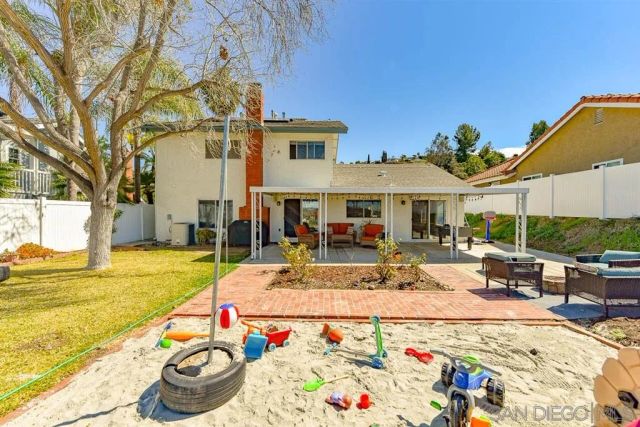 a view of a white house with swimming pool table and chairs