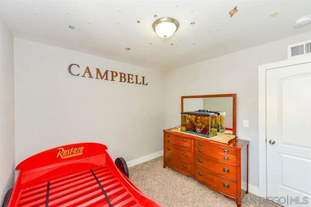 a bedroom with a bed and a dresser in it