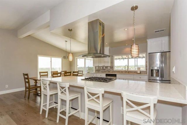 a large kitchen with a table and chairs
