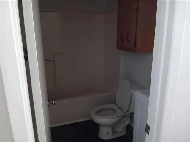a bathroom with a toilet and a sink