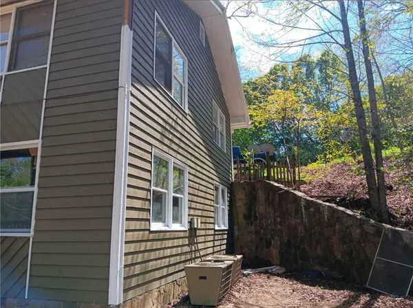 a view of a house with a wooden deck
