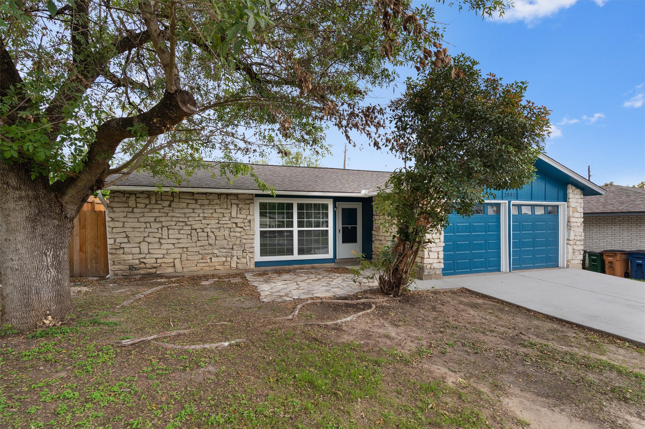 2532 Chaparral Trail Austin, TX 78744 - Photo 2 of 27 a view of a house with a large tree and yard