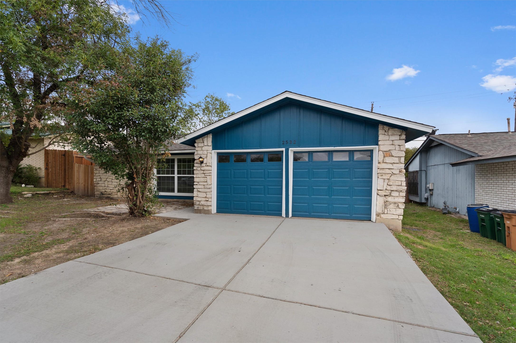 2532 Chaparral Trail Austin, TX 78744 - Photo 3 of 27 a front view of a house with a yard and garage