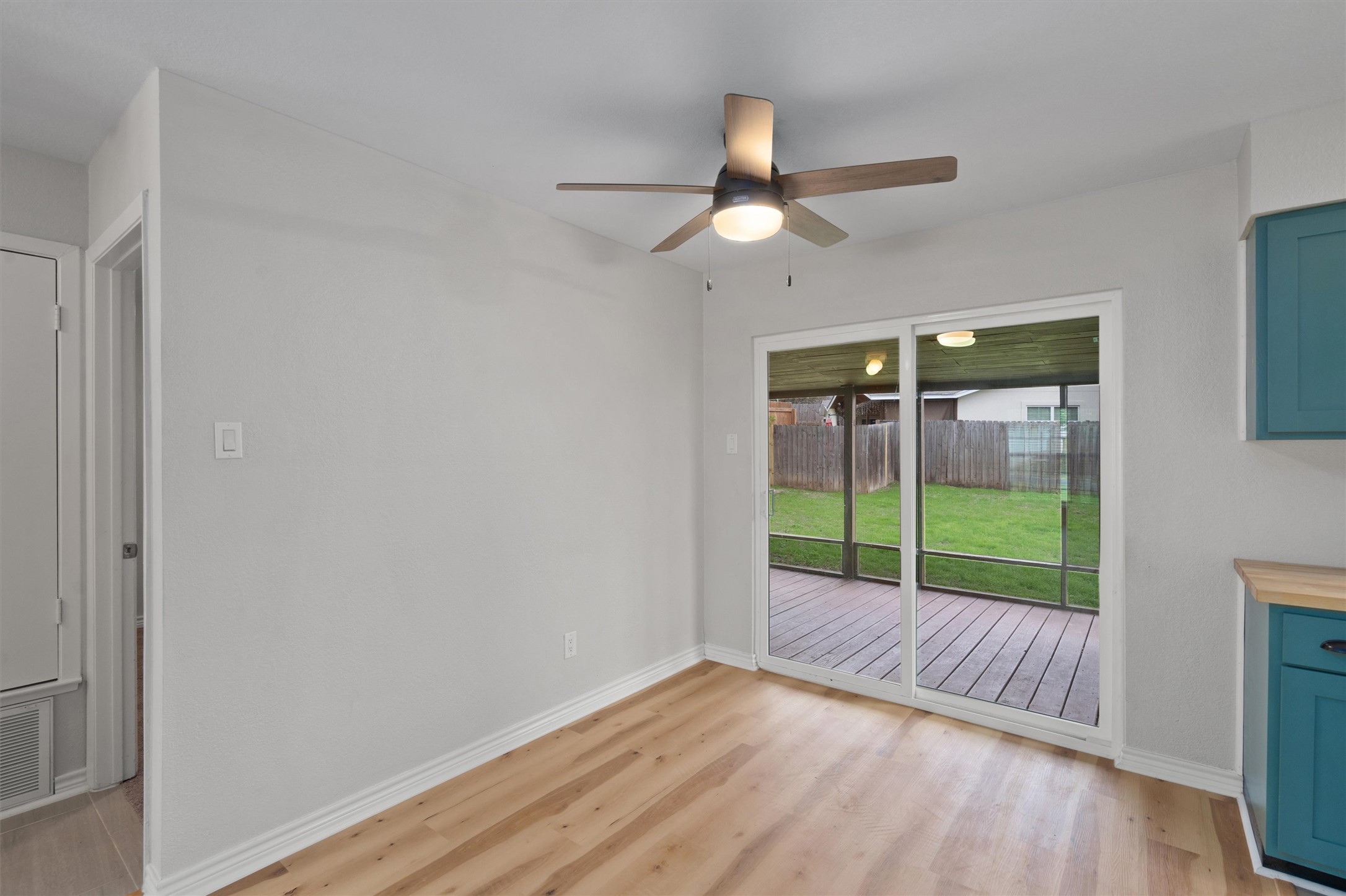 2532 Chaparral Trail Austin, TX 78744 - Photo 7 of 27 a view of an empty room with wooden floor and a window