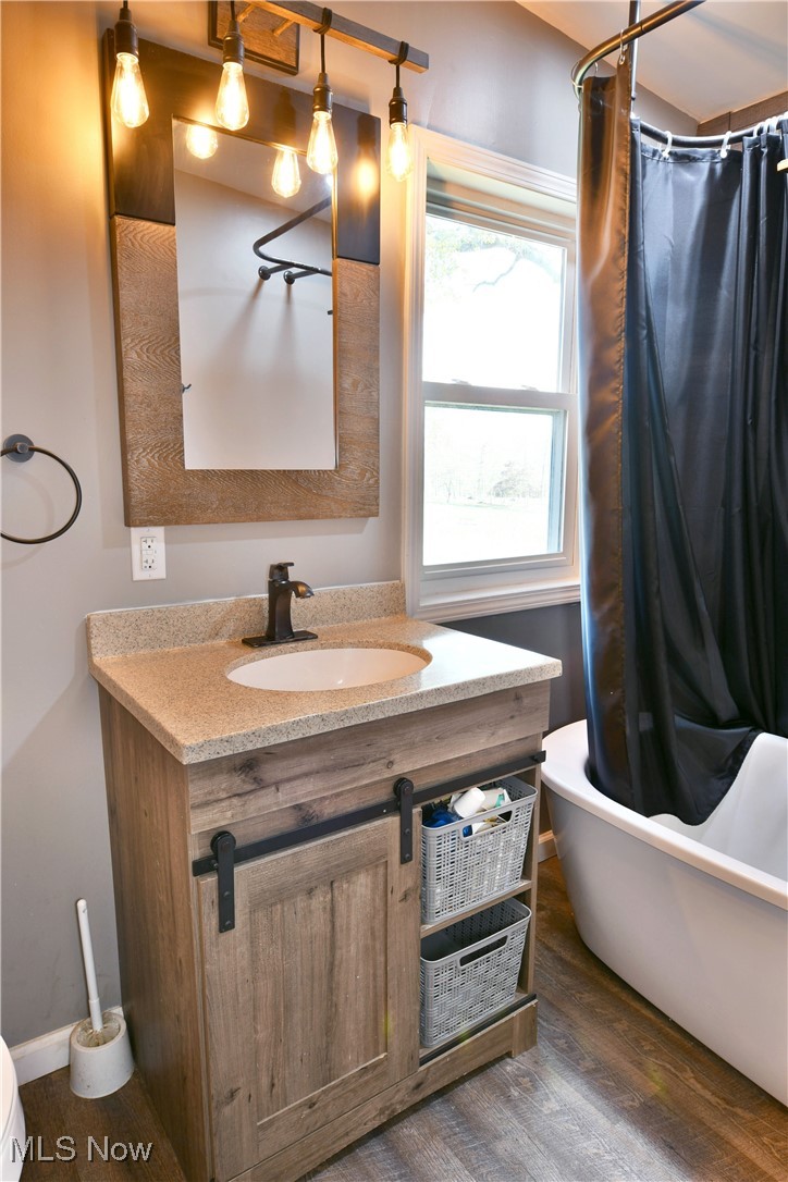 600 Prentice Road Northwest Warren, OH 44481 - Photo 40 of 47 Full bathroom with shower / bath combo, hardwood / wood-style floors, vanity, and toilet