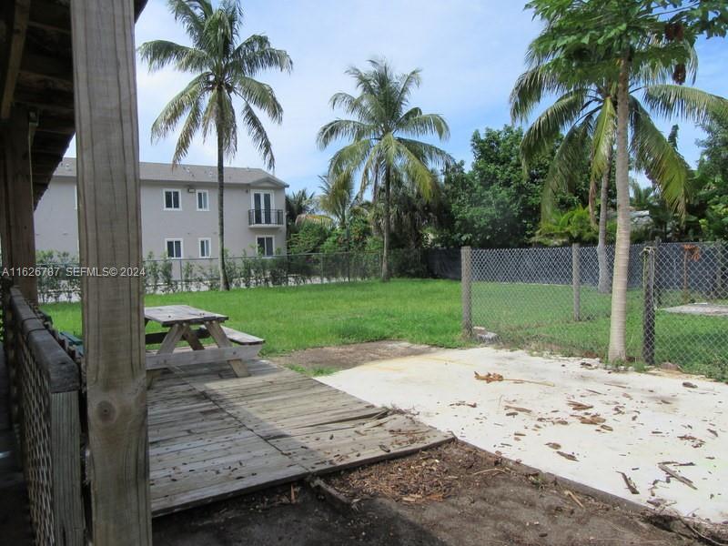 24925 Southwest 134th Court Homestead, FL 33032 - Photo 11 of 37 a view of a backyard with a garden and palm trees
