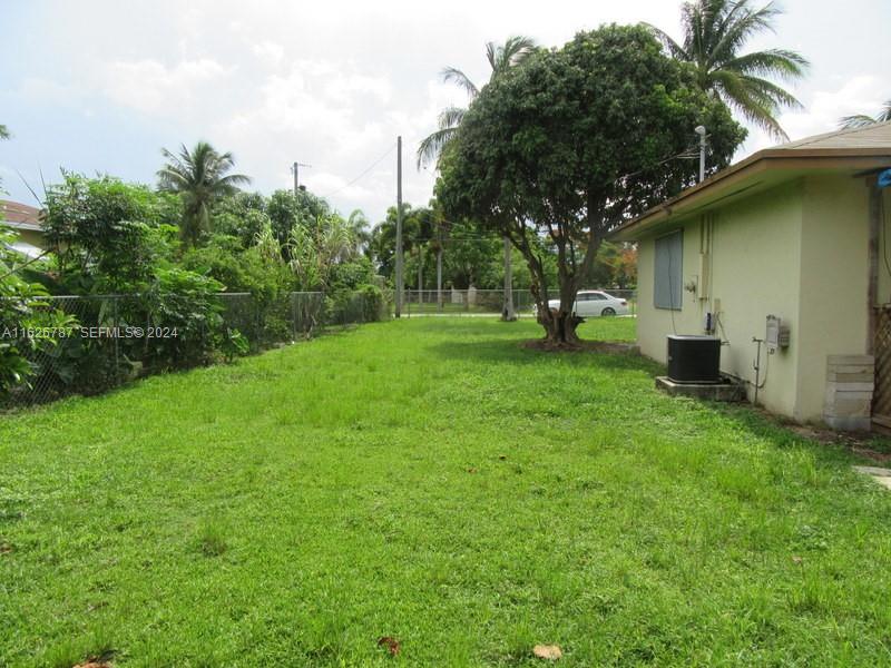 24925 Southwest 134th Court Homestead, FL 33032 - Photo 12 of 37 a view of a backyard with potted plants and large trees