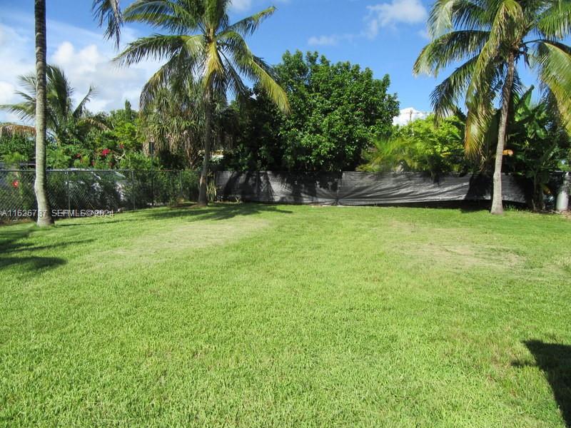 24925 Southwest 134th Court Homestead, FL 33032 - Photo 14 of 37 a backyard of a house with palm trees