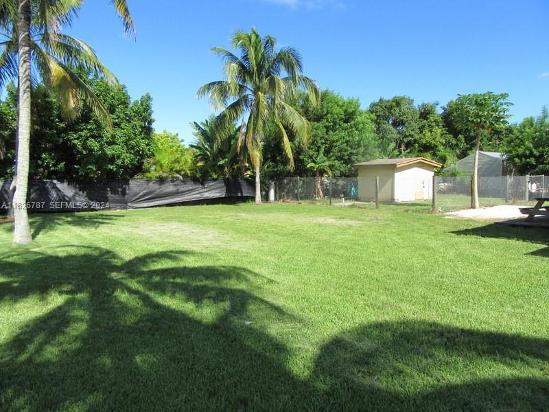 24925 Southwest 134th Court Homestead, FL 33032 - Photo 17 of 37 a backyard of a house with table and chairs