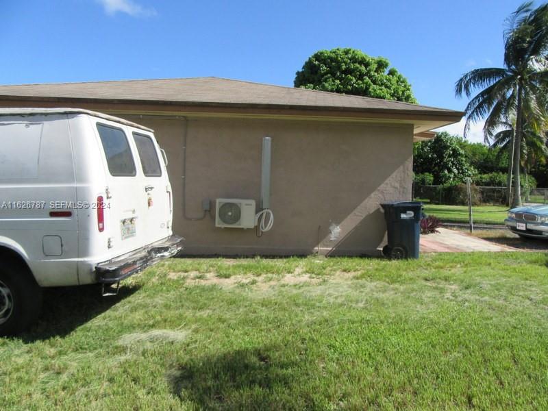 24925 Southwest 134th Court Homestead, FL 33032 - Photo 18 of 37 a view of a back yard of the house with a bench
