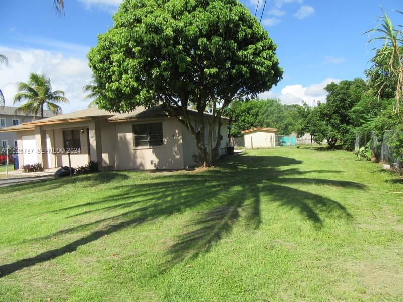 24925 Southwest 134th Court Homestead, FL 33032 - Photo 25 of 37 a front view of a house with a garden