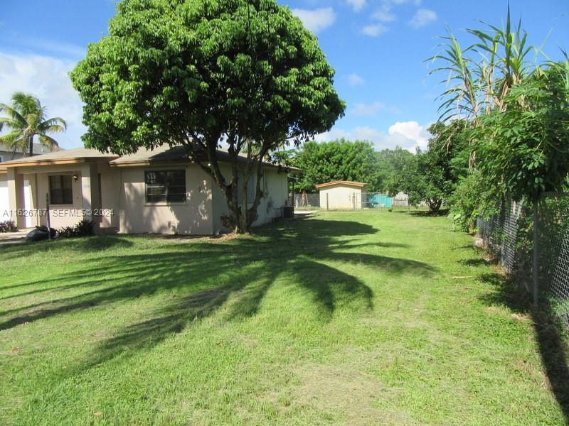 24925 Southwest 134th Court Homestead, FL 33032 - Photo 26 of 37 a front view of a house with garden