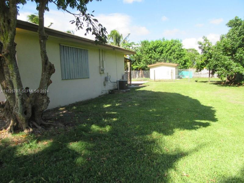 24925 Southwest 134th Court Homestead, FL 33032 - Photo 29 of 37 a front view of a house with garden