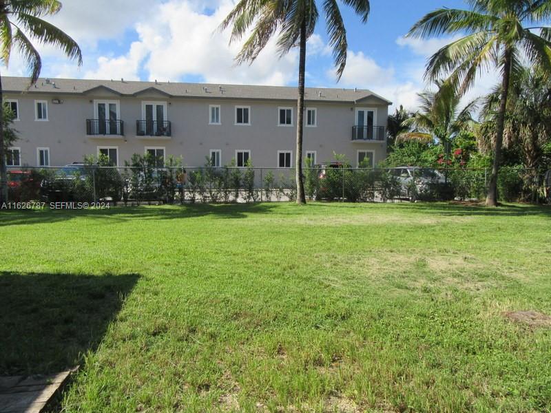 24925 Southwest 134th Court Homestead, FL 33032 - Photo 34 of 37 a front view of a house with a garden and trees