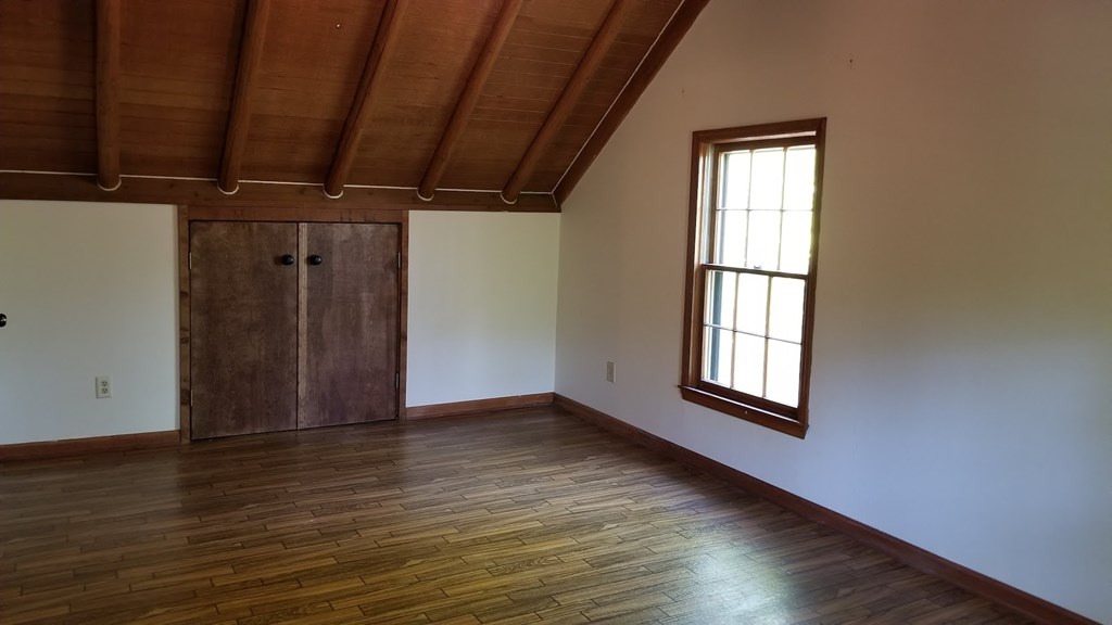 5212 Lick Skillet Road Hamilton, GA 31811 - Photo 8 of 17 a view of an empty room with wooden floor and a window