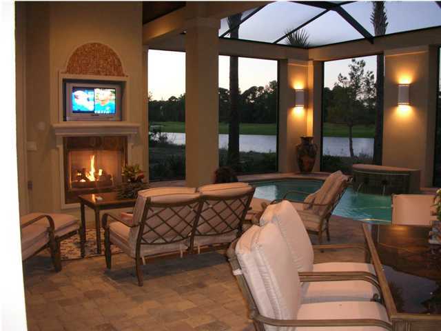 2945 Pine Valley Road Miramar Beach, FL 32550 - Photo 17 of 20 a living room with furniture a floor to ceiling window and a flat screen tv
