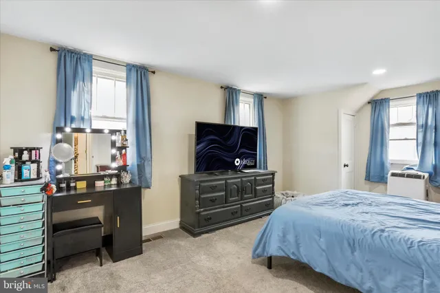 a bedroom with a bed and flat screen tv