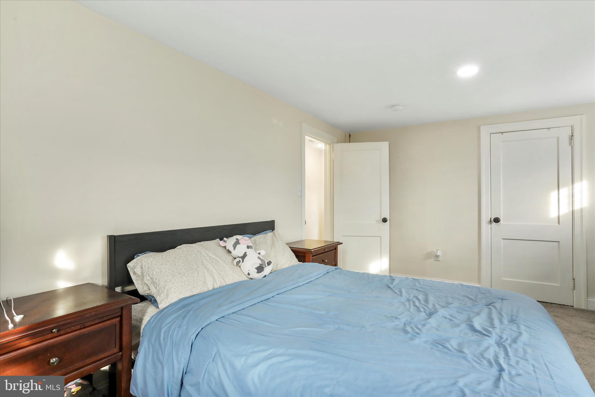 8118 Mapleville Road Boonsboro, MD 21713 - Photo 16 of 30 a bedroom with a bed and a lamp with wall painting