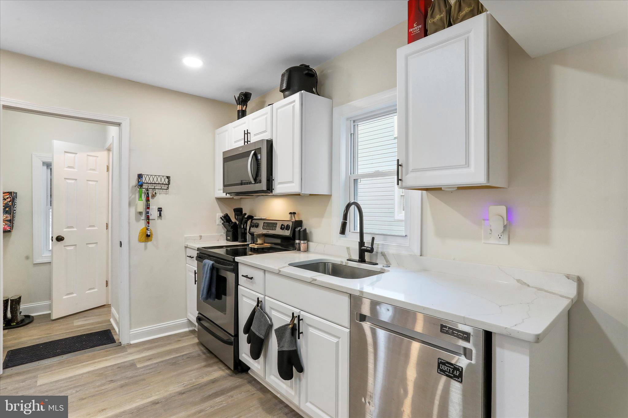 8118 Mapleville Road Boonsboro, MD 21713 - Photo 7 of 30 a kitchen with stainless steel appliances granite countertop a sink stove and refrigerator