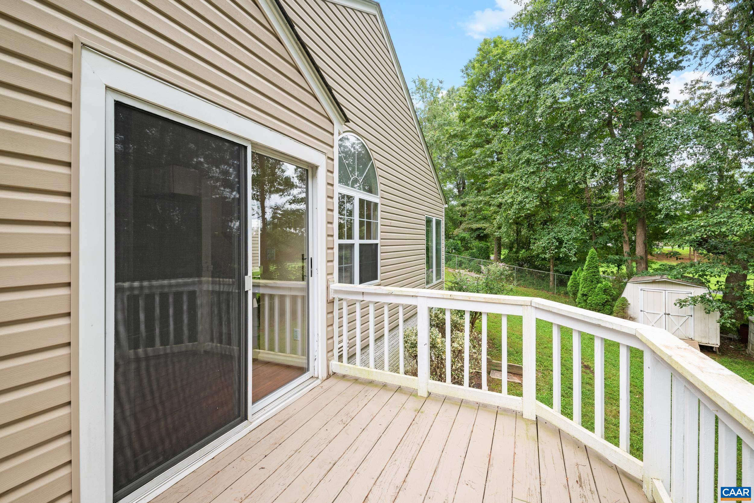 183 Rustling Oaks Way Ruckersville, VA 22968 - Photo 20 of 52 a view of a wooden house with a deck