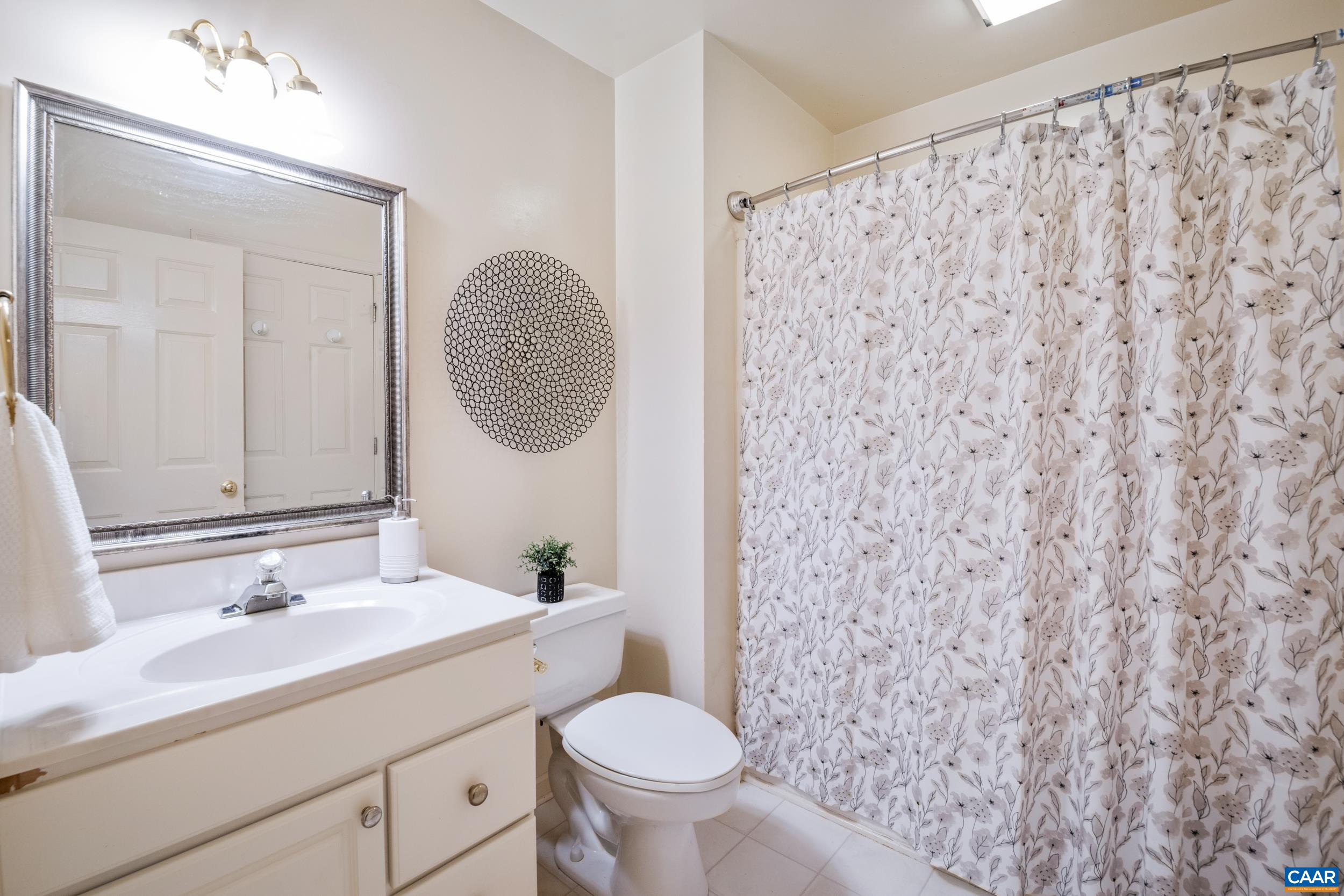 183 Rustling Oaks Way Ruckersville, VA 22968 - Photo 26 of 52 a bathroom with a granite countertop sink toilet and a mirror