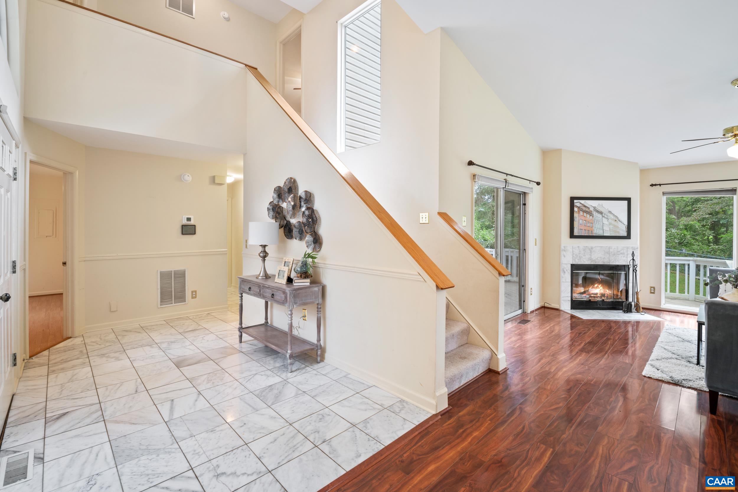 183 Rustling Oaks Way Ruckersville, VA 22968 - Photo 32 of 52 a view of a livingroom with wooden floor and staircase