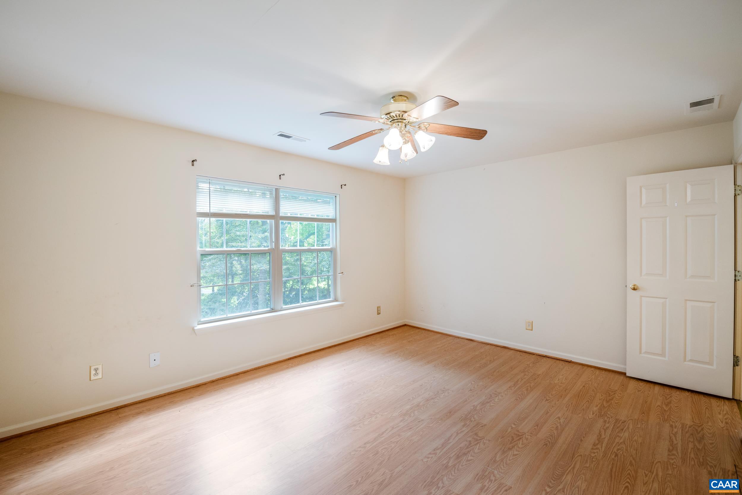 183 Rustling Oaks Way Ruckersville, VA 22968 - Photo 34 of 52 an empty room with wooden floor and windows