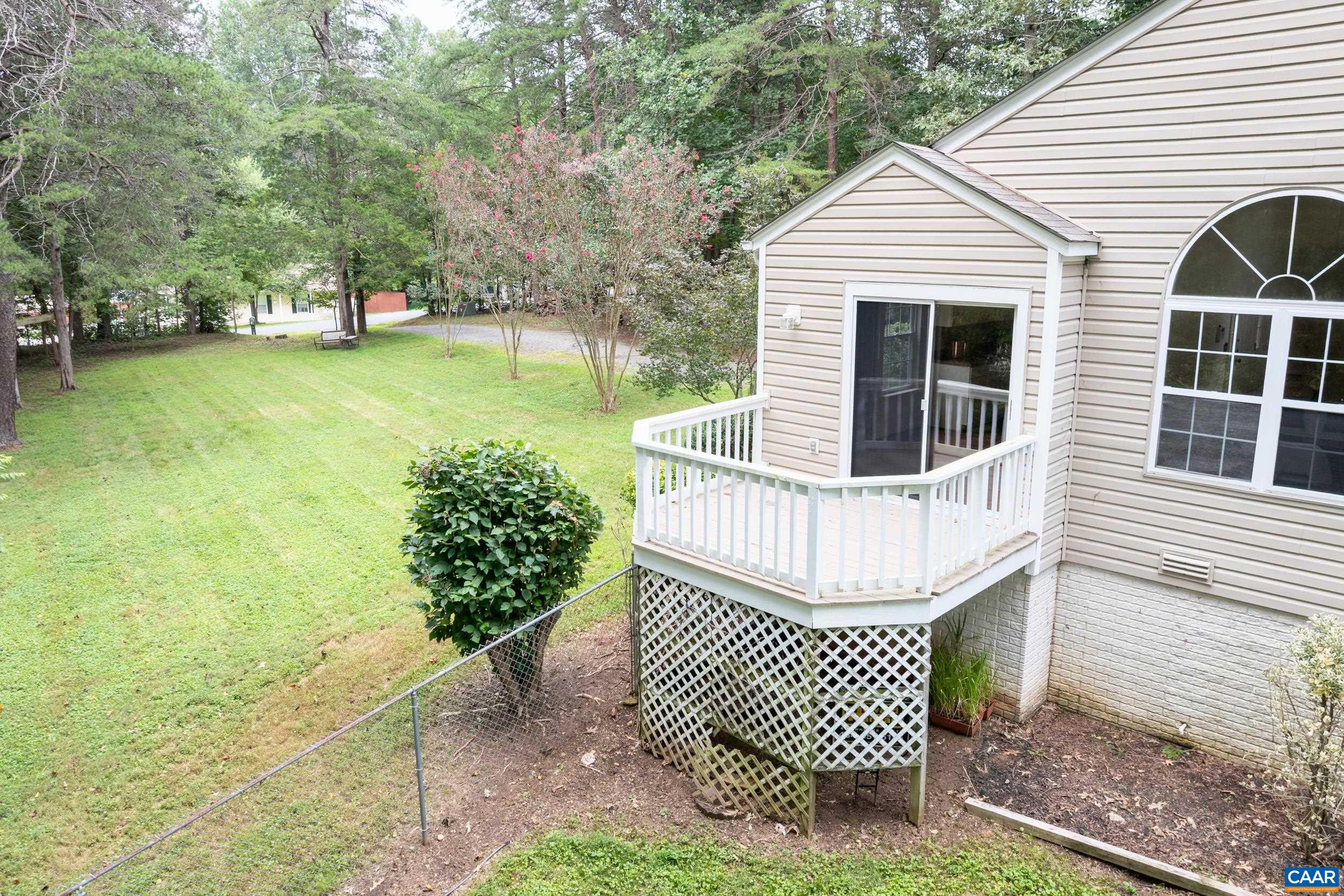 183 Rustling Oaks Way Ruckersville, VA 22968 - Photo 43 of 52 a front view of a house with a garden