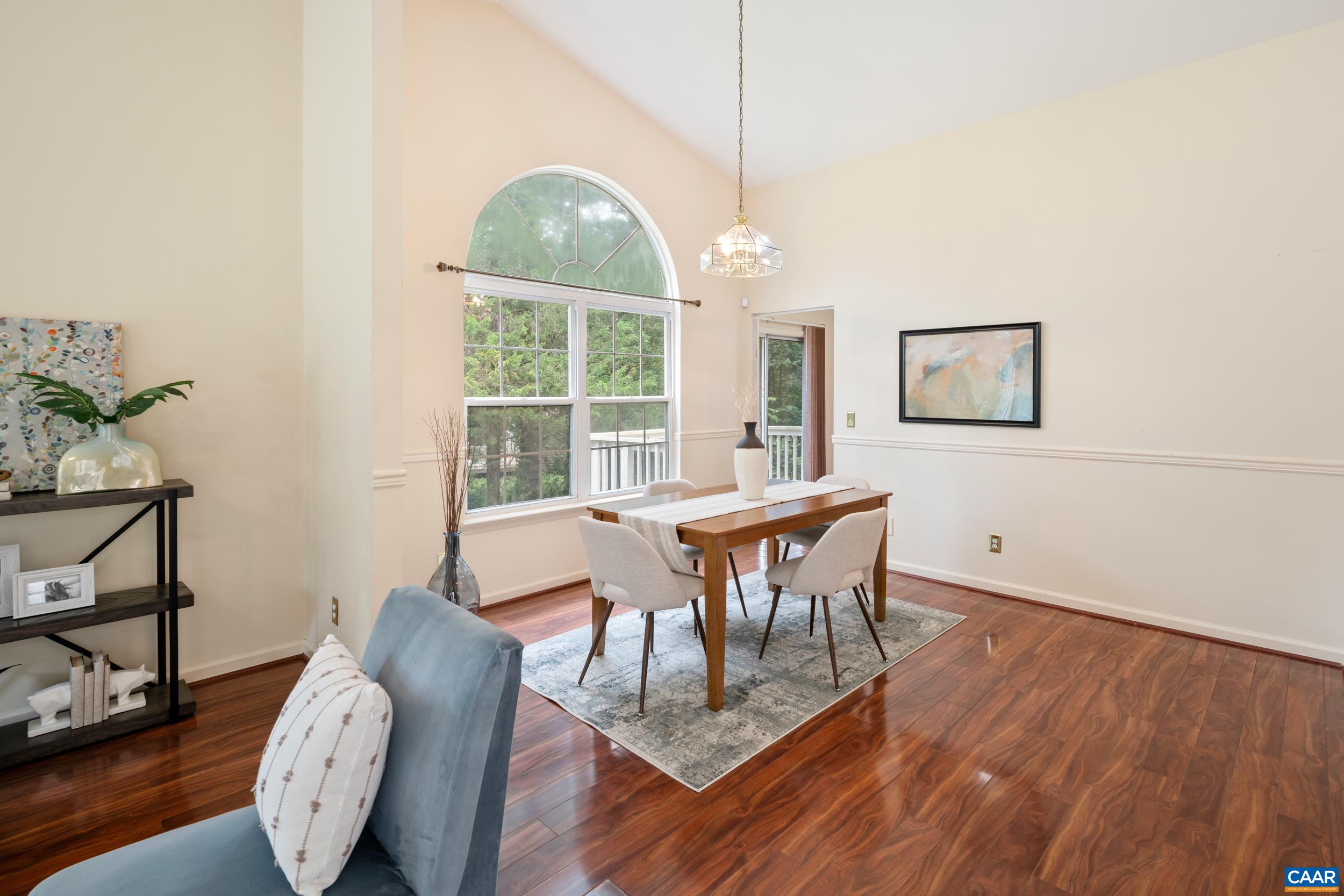 183 Rustling Oaks Way Ruckersville, VA 22968 - Photo 8 of 52 a dining room with furniture a window and wooden floor