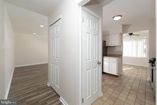 a spacious bedroom with a bed and a chair