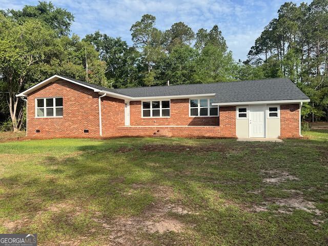 2809 Jones Road Sandersville, GA 31082 - Photo 1 of 31 a front view of a house with a garden