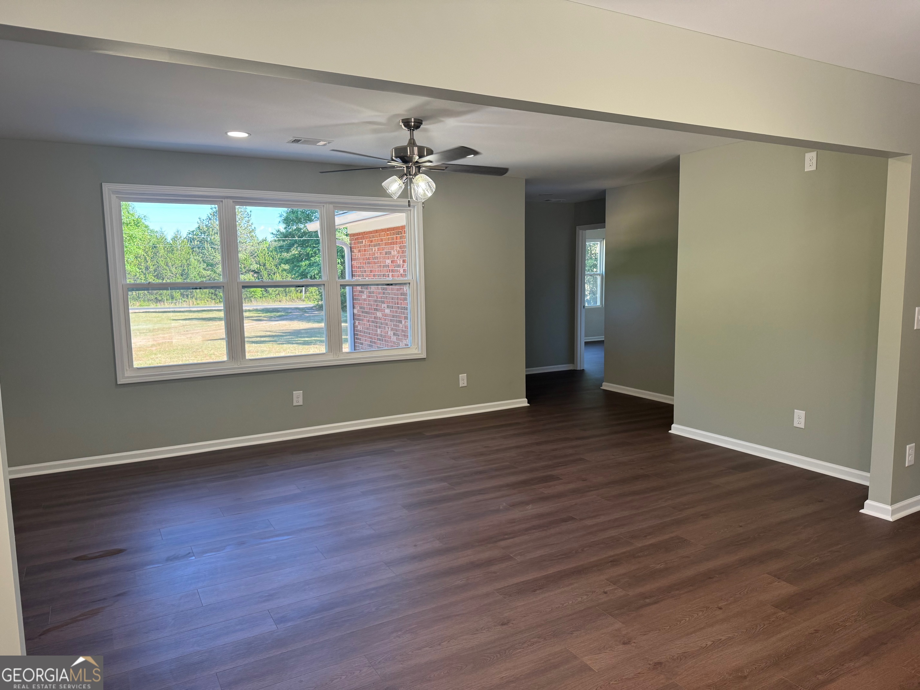 2809 Jones Road Sandersville, GA 31082 - Photo 18 of 31 an empty room with wooden floor and windows